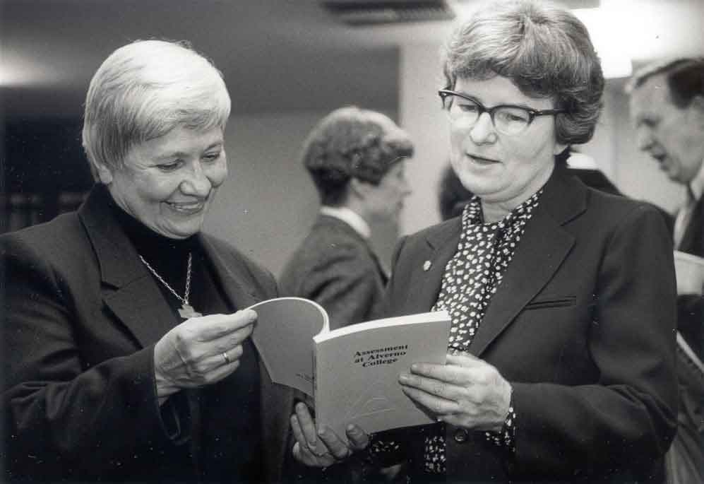 Sr. Georgine Loacker and Sr. Austin Doherty look at the second edition of "Assessment at Alverno College published in 1985.