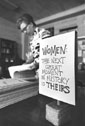 Small Photo: Sister Marian Schreiner in RCW adjacent to sign reading:"Women: The Next Great Moment in History is Theirs."
